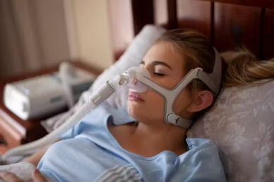 Woman-using-CPAP-machine-to-sleep